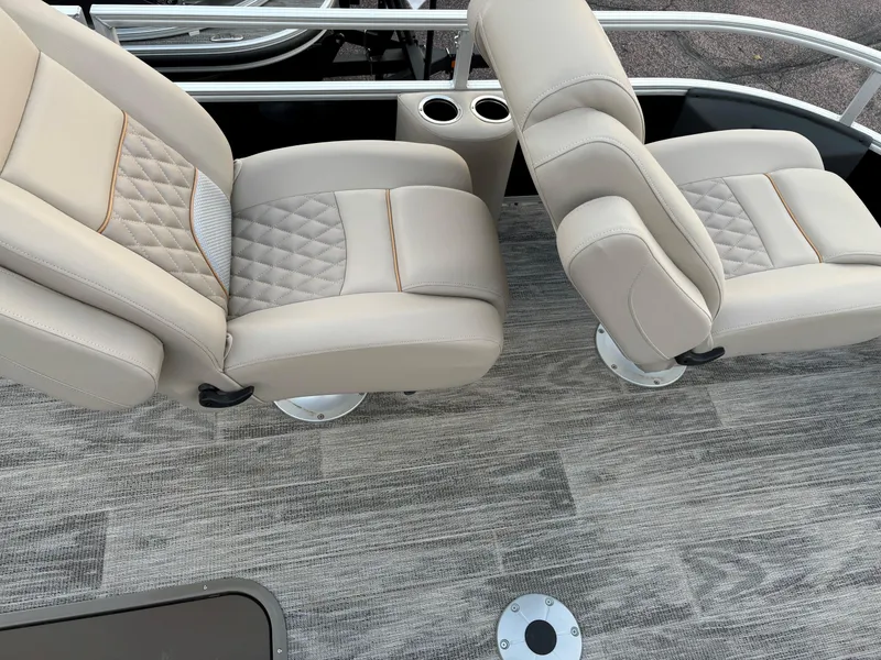 Slide: The Image of 2024 Ranger Reata 223FC boat seats with beige upholstery and textured flooring. - 11