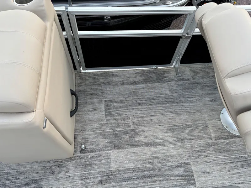 Slide: The Image of 2024 Ranger Reata 223FC boat interior with beige seats and gray flooring. - 12