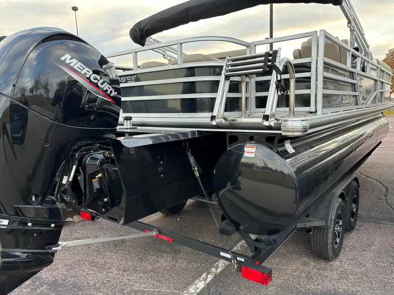 Slide: The Image of 2024 Ranger Reata 223FC pontoon boat with Mercury engine, parked on a trailer. - 5