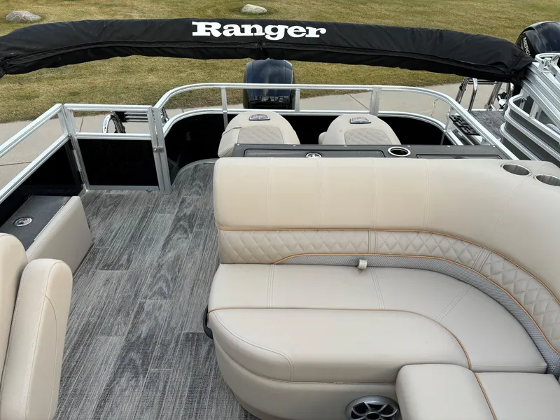 Slide: The Image of 2024 Ranger Reata 223FC pontoon boat with beige seating and sleek design. - 9