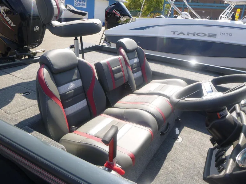 Slide: The Image of 2024 Ranger RT188C boat interior with gray and red seats, steering wheel, and console. - 11