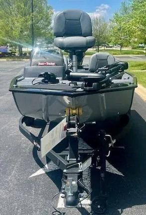 Slide: The Image of 2025 Tracker Bass Tracker Classic XL boat parked outdoors on a sunny day. - 2