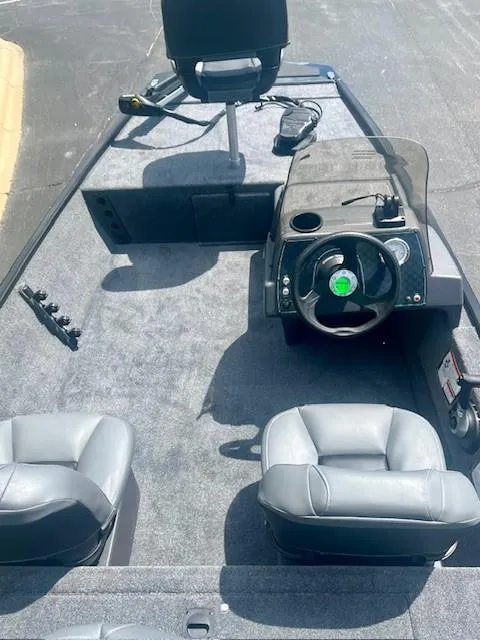 Slide: The Image of 2025 Tracker Bass Tracker Classic XL boat interior with steering console and seating. - 3