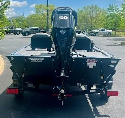 Slide: The Image of 2025 Tracker Bass Tracker Classic XL boat with 50HP motor in parking lot. - 4