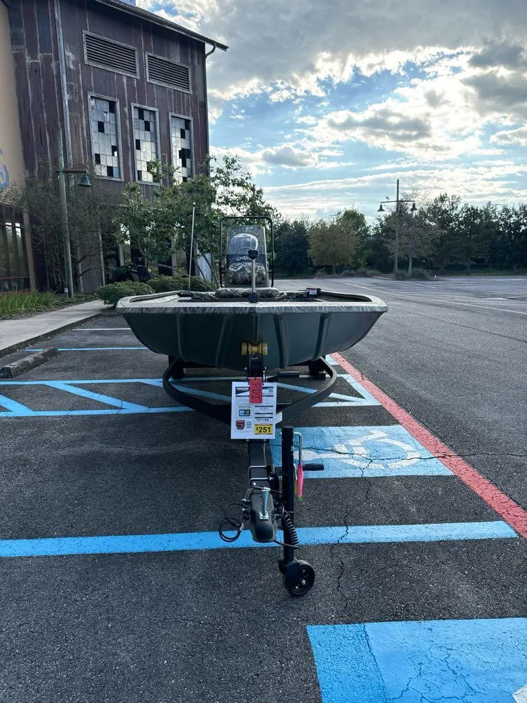 Slide: The Image of 2025 Tracker Grizzly 1860 CC boat parked in a lot under a cloudy sky. - 3