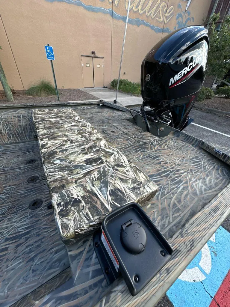 Slide: The Image of 2025 Tracker Grizzly 1860 CC boat with Mercury engine in parking lot. - 6