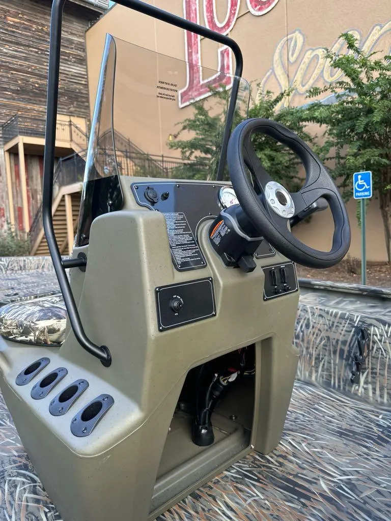 Slide: The Image of 2025 Tracker Grizzly 1860 CC boat console with steering wheel and controls. - 7