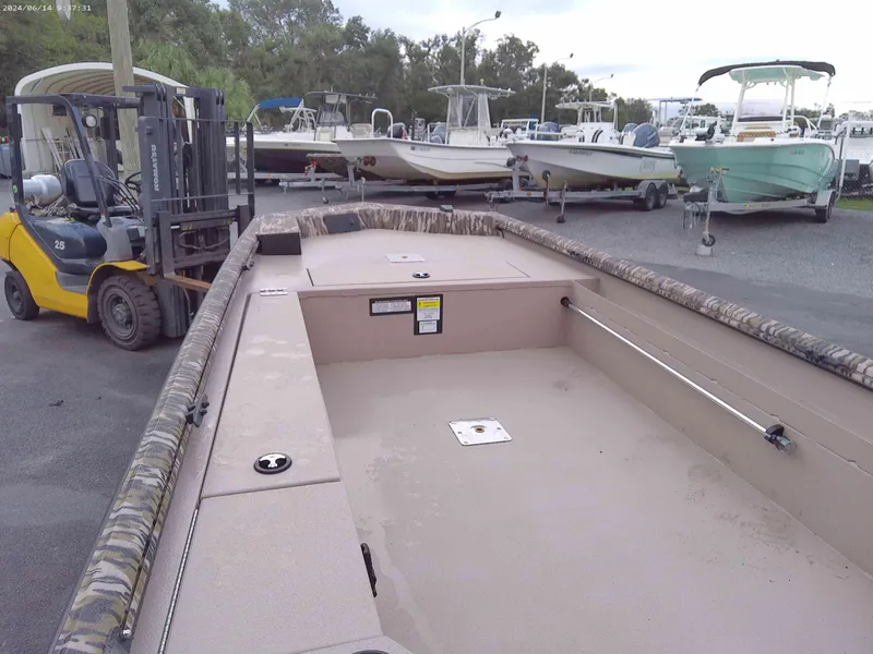 Slide: The Image of 2025 Avid 16 Commander boat in a marina with forklift nearby. - 3
