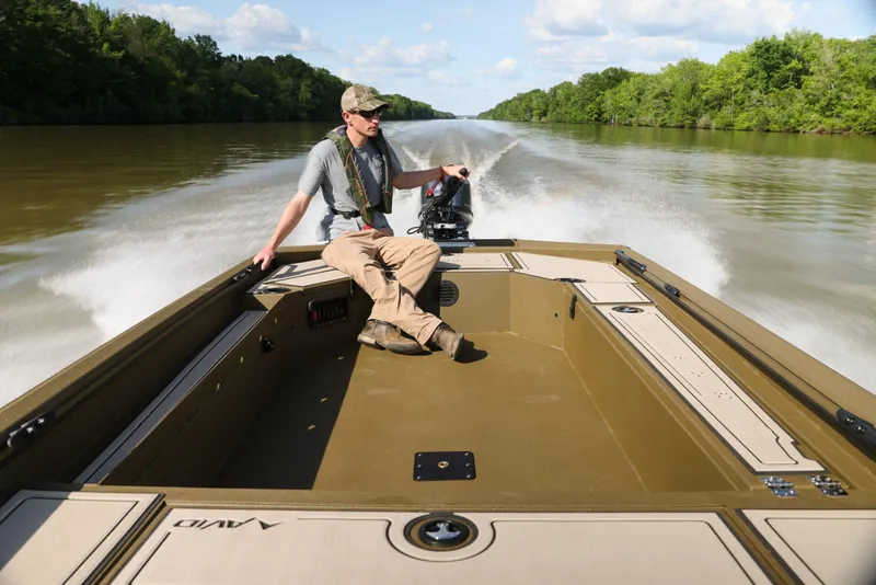 Slide: The Image of Man driving 2025 Avid 16 Commander boat on a river. - 6