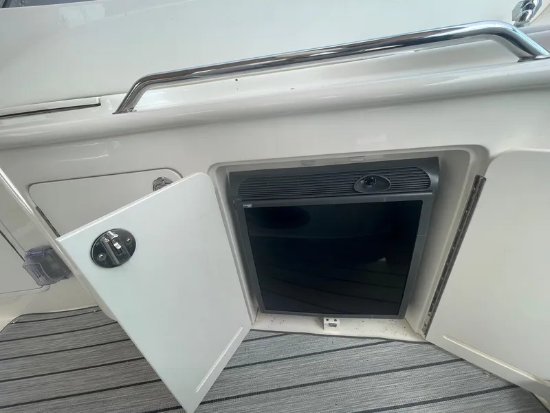 Slide: The Image of Open storage compartment on 2002 Sea Ray 340 Sundancer boat deck. - 18