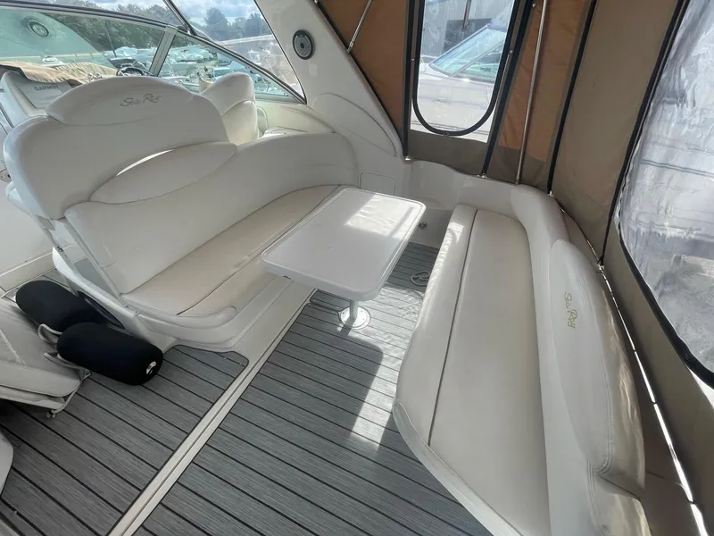 Slide: The Image of Interior of 2002 Sea Ray 340 Sundancer with white seating and table. - 20