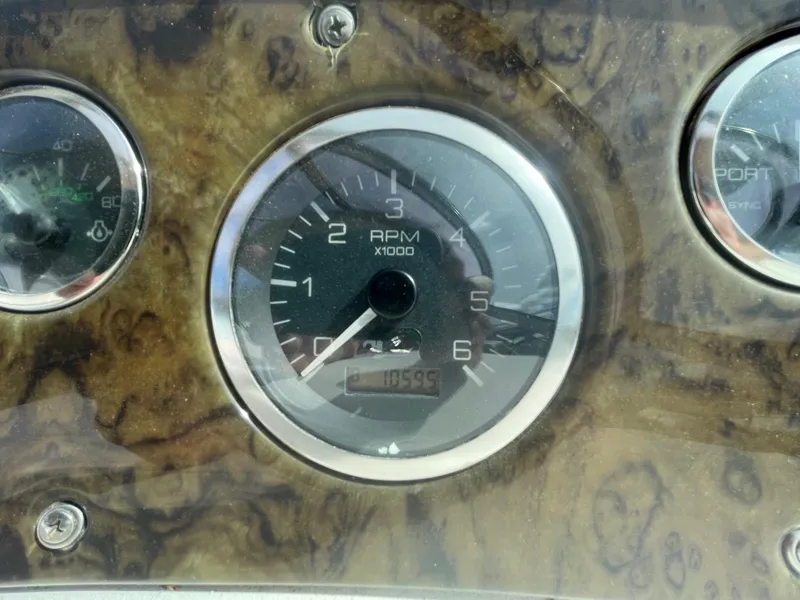 Slide: The Image of Close-up of 2002 Sea Ray 340 Sundancer RPM gauge on wooden dashboard. - 28