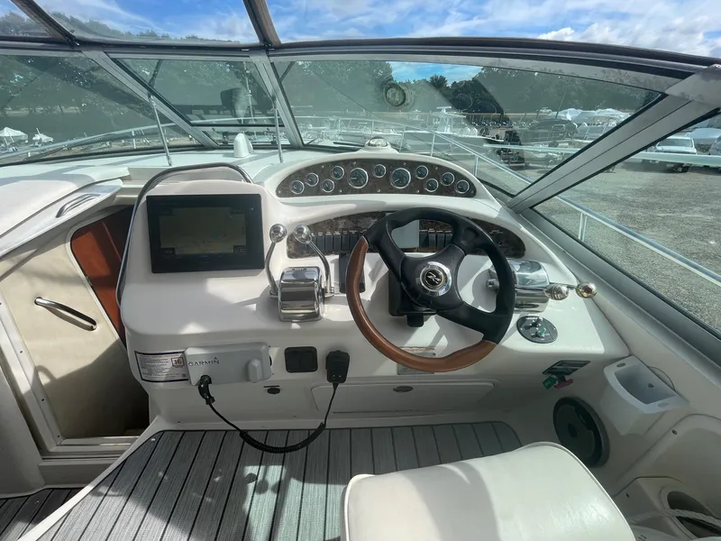 Slide: The Image of 2002 Sea Ray 340 Sundancer helm with steering wheel, gauges, and navigation system. - 29