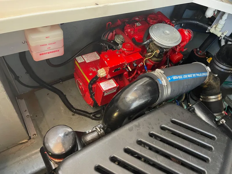 Slide: The Image of Engine compartment of 2002 Sea Ray 340 Sundancer with red components and hoses. - 32