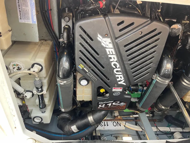 Slide: The Image of 2002 Sea Ray 340 Sundancer engine compartment with Mercury engine. - 34
