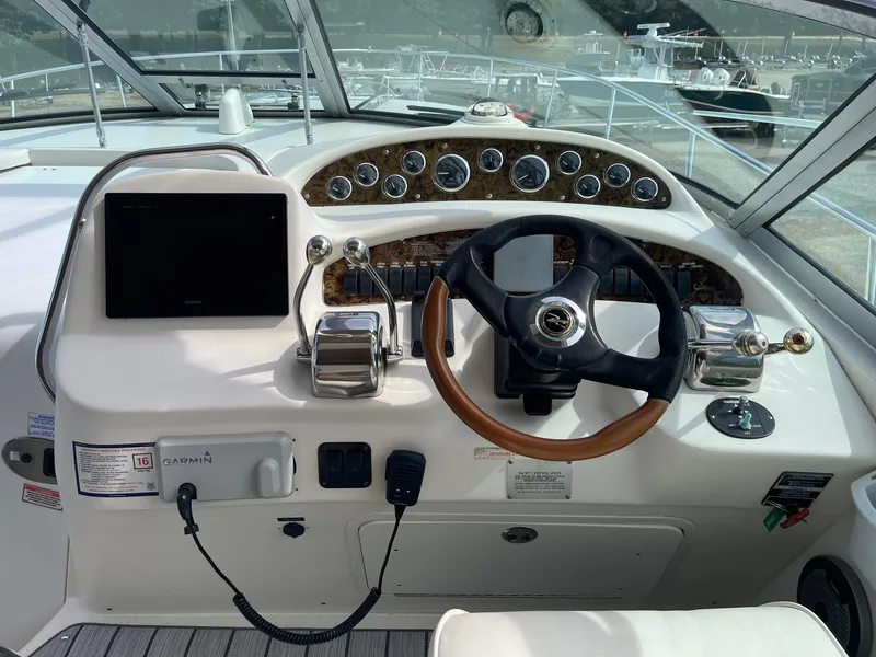 Slide: The Image of Cockpit of 2002 Sea Ray 340 Sundancer with steering wheel and control panel. - 35