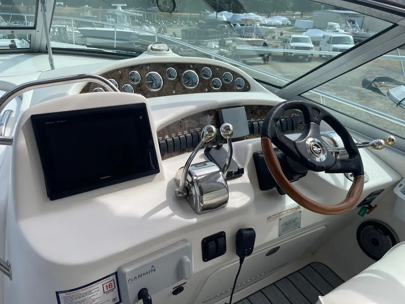 Slide: The Image of Cockpit of 2002 Sea Ray 340 Sundancer with steering wheel and navigation controls. - 36