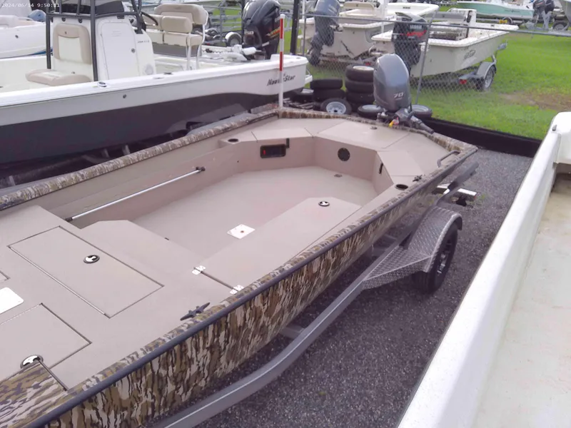 Slide: The Image of 2025 Avid 18 Commander boat with camouflage design on a trailer. - 5