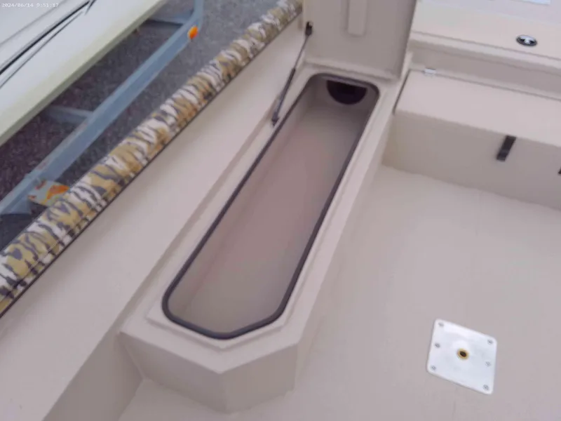 Slide: The Image of Avid 18 Commander 2025 boat storage compartment with open lid. - 6