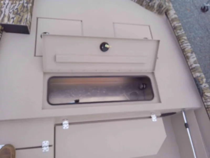 Slide: The Image of 2025 Avid 18 Commander boat storage compartment with open hatch. - 7