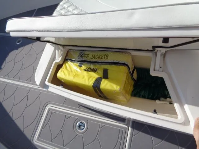Slide: The Image of Storage compartment on 2022 Contender 32 ST boat with life jackets and rope. - 12