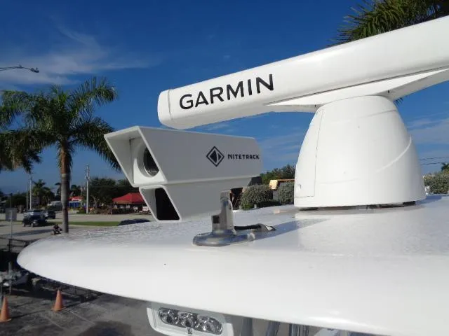 Slide: The Image of Garmin radar and Nitetrek camera on 2022 Contender 32 ST boat, with palm trees in background. - 14