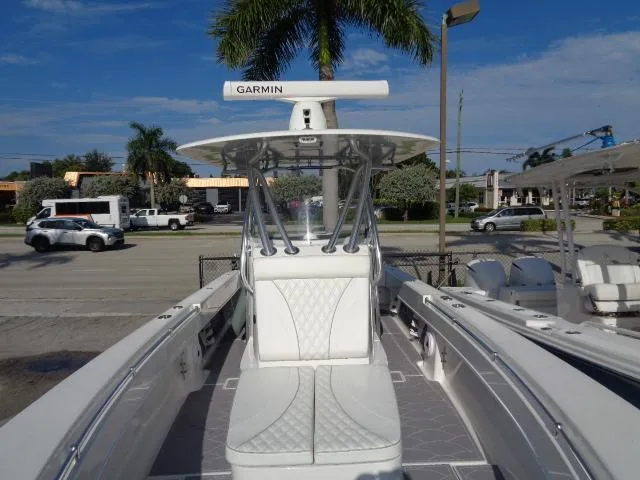 Slide: The Image of 2022 Contender 32 ST boat with Garmin radar, docked under a clear blue sky. - 15