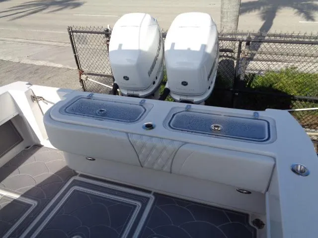 Slide: The Image of 2022 Contender 32 ST boat with dual outboard engines and cushioned seating. - 16