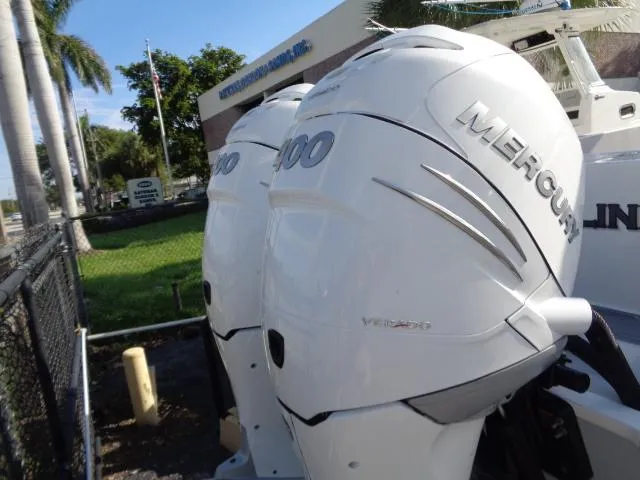 Slide: The Image of 2022 Contender 32 ST with twin Mercury 400 outboard engines, parked outdoors. - 3