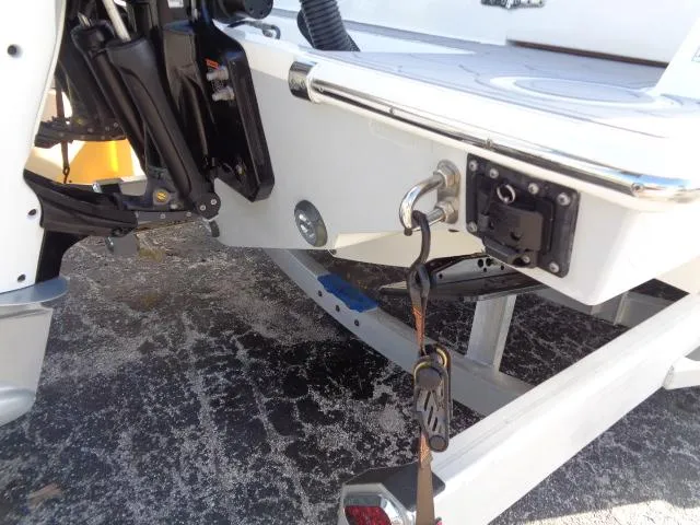 Slide: The Image of 2022 Contender 32 ST boat on trailer, showing engine mount and tie-down strap. - 4