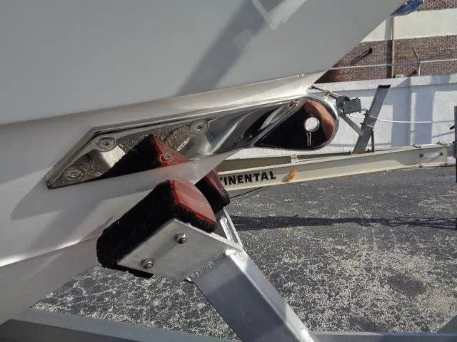 Slide: The Image of 2022 Contender 32 ST boat on trailer, close-up of hull and support brackets. - 6