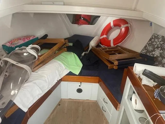 Slide: The Image of Interior of 1981 SISU 26 boat cabin with life preserver and wooden furnishings. - 5