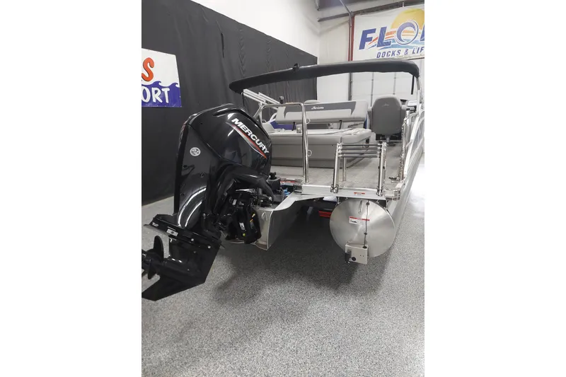 Slide: The Image of 2025 Barletta ARIA 22UC pontoon boat with Mercury outboard motor in showroom. - 11