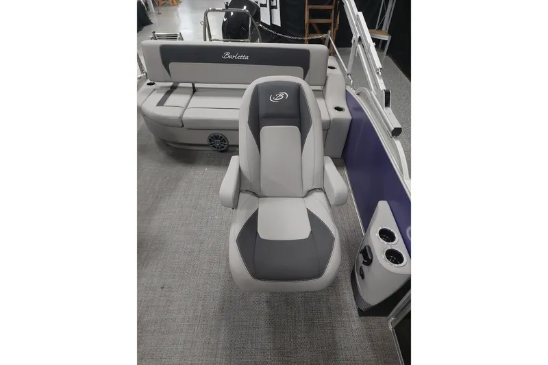 Slide: The Image of 2025 Barletta ARIA 22UC boat interior with luxurious seating and cup holders. - 8