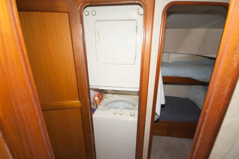 Slide: The Image of Laundry area with washer and dryer on 1997 Ocean Yachts 53 Super Sport. - 12