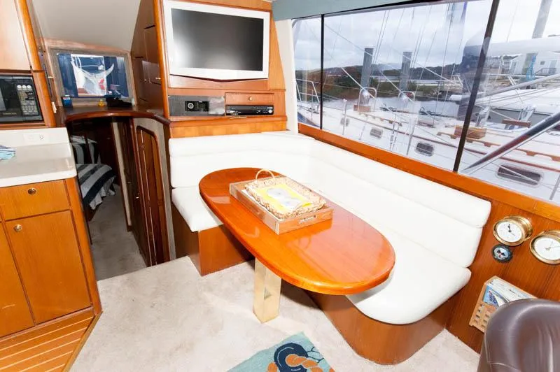 Slide: The Image of Interior of 1997 Ocean Yachts 53 Super Sport with dining area and large window view. - 17