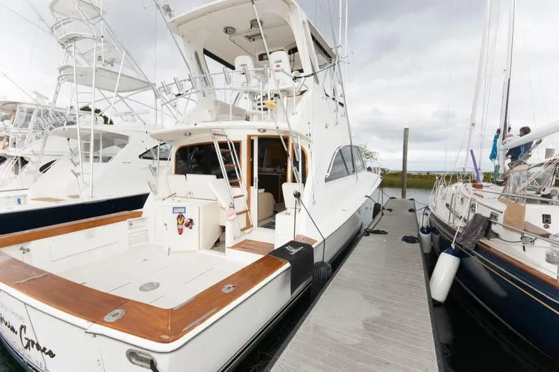Slide: The Image of 1997 Ocean Yachts 53 Super Sport docked, featuring spacious deck and flybridge. - 2