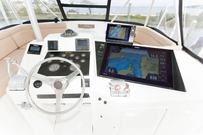 Slide: The Image of Cockpit of 1997 Ocean Yachts 53 Super Sport with navigation screens and steering wheel. - 21