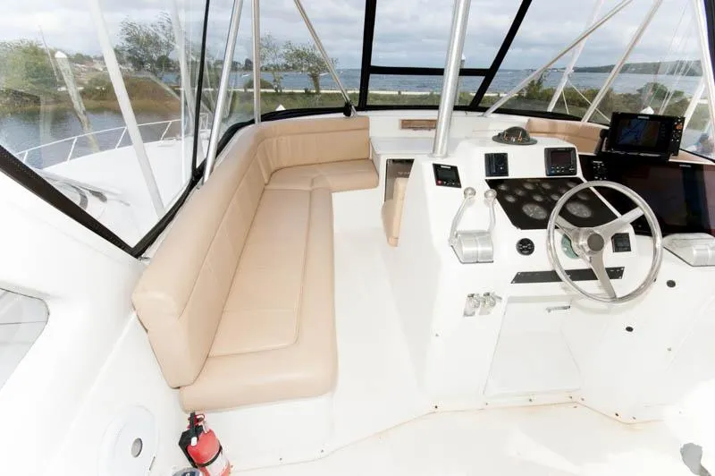 Slide: The Image of 1997 Ocean Yachts 53 Super Sport helm with beige seating and modern controls. - 23