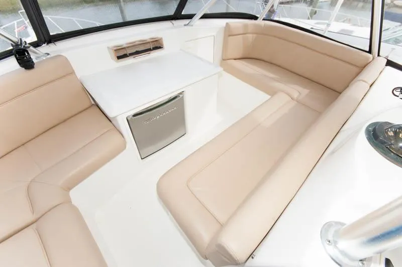 Slide: The Image of Luxurious seating area on 1997 Ocean Yachts 53 Super Sport with beige cushions and table. - 24