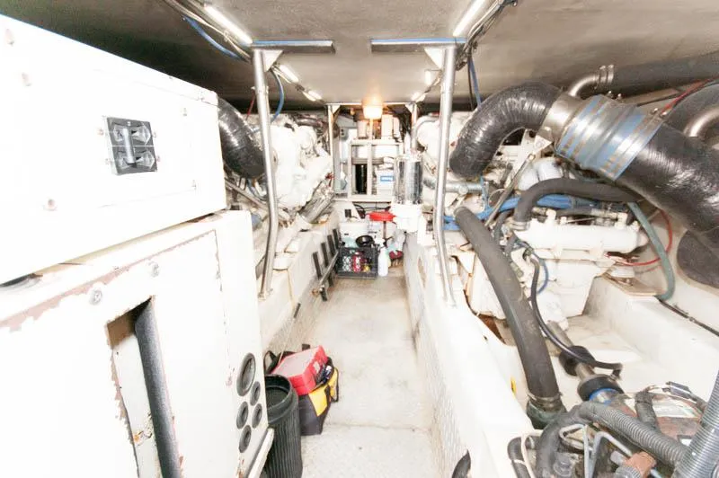 Slide: The Image of Engine room of a 1997 Ocean Yachts 53 Super Sport, showcasing mechanical components. - 28