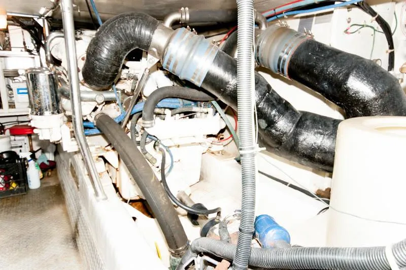Slide: The Image of Engine room of a 1997 Ocean Yachts 53 Super Sport with visible hoses and machinery. - 29