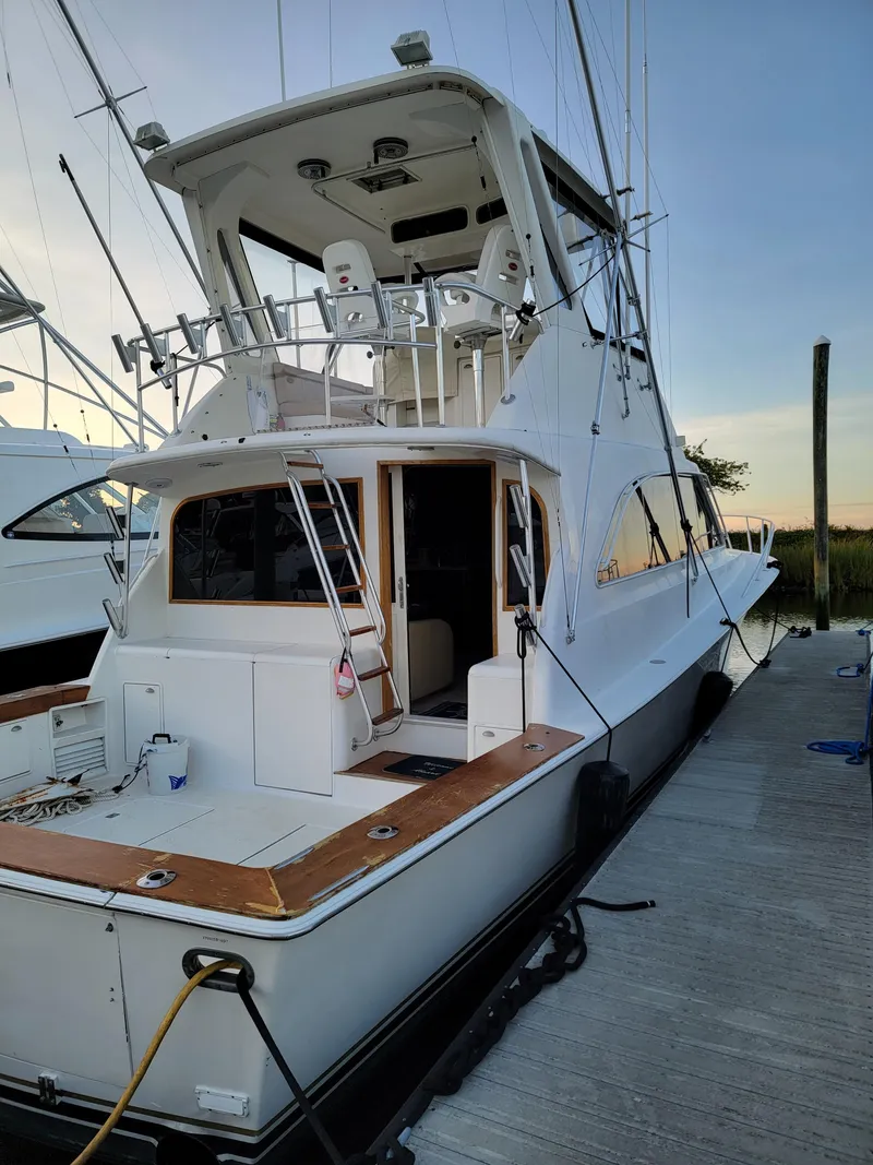 Slide: The Image of 1997 Ocean Yachts 53 Super Sport docked, showcasing sleek design and spacious deck. - 3