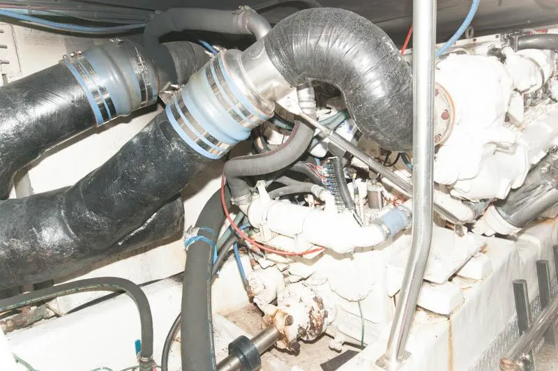 Slide: The Image of Engine room of a 1997 Ocean Yachts 53 Super Sport with visible hoses and machinery. - 30