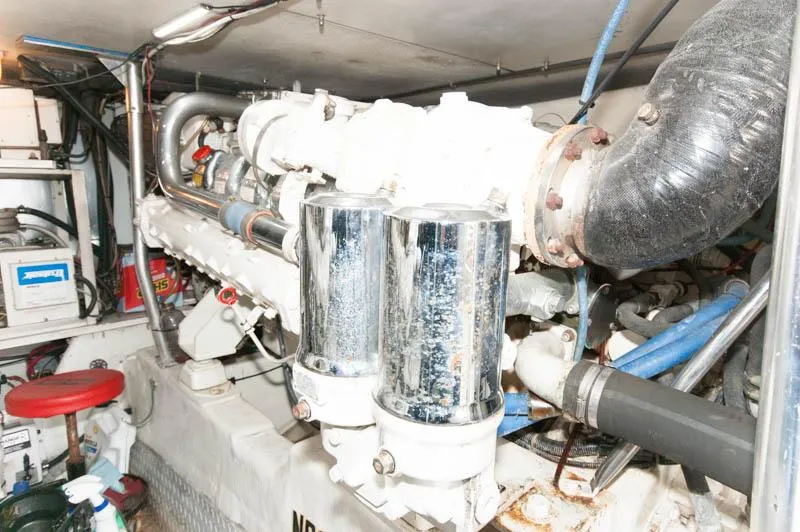 Slide: The Image of Engine room of 1997 Ocean Yachts 53 Super Sport, showcasing mechanical components and piping. - 32