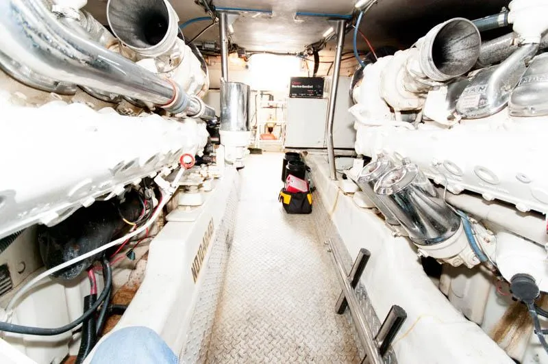 Slide: The Image of Engine room of 1997 Ocean Yachts 53 Super Sport, showcasing dual engines and mechanical components. - 33