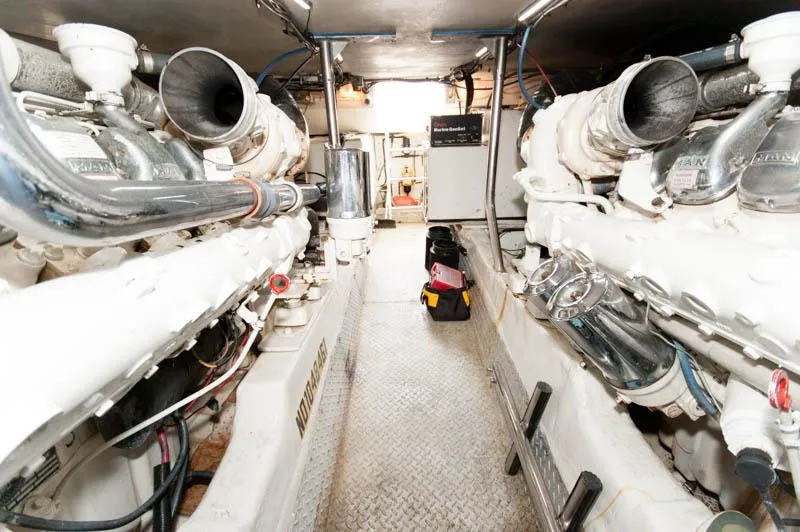 Slide: The Image of Engine room of a 1997 Ocean Yachts 53 Super Sport, showcasing dual engines and equipment. - 34