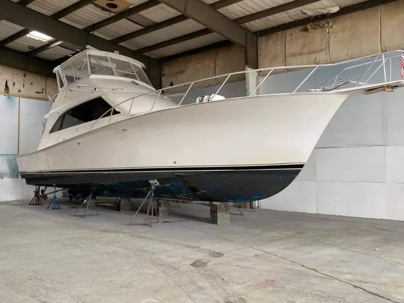 Slide: The Image of 1997 Ocean Yachts 53 Super Sport in a boatyard, elevated on stands. - 4