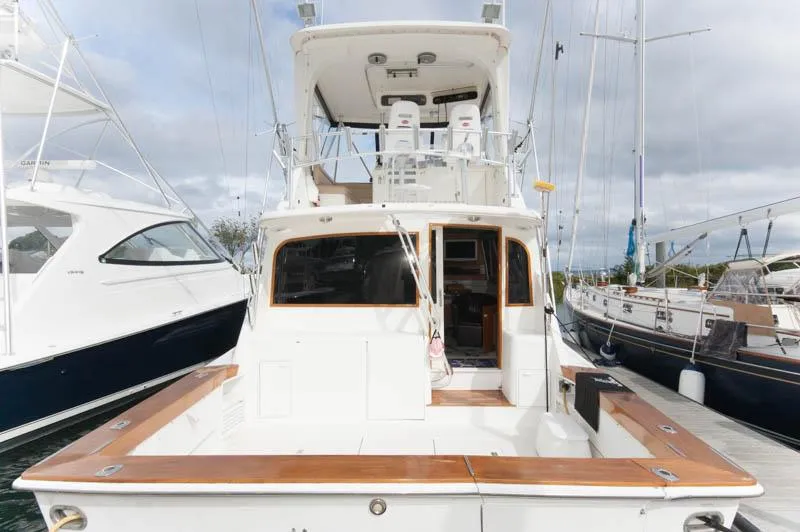 Slide: The Image of 1997 Ocean Yachts 53 Super Sport docked, showcasing spacious deck and flybridge. - 5
