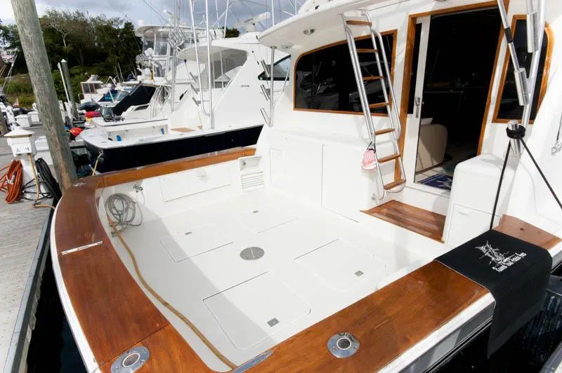 Slide: The Image of 1997 Ocean Yachts 53 Super Sport docked, featuring spacious deck and elegant wood trim. - 6